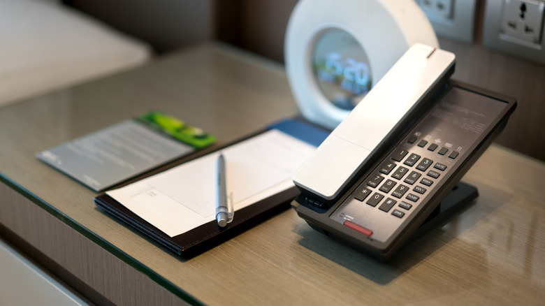 Pen and stationary next to hotel phone
