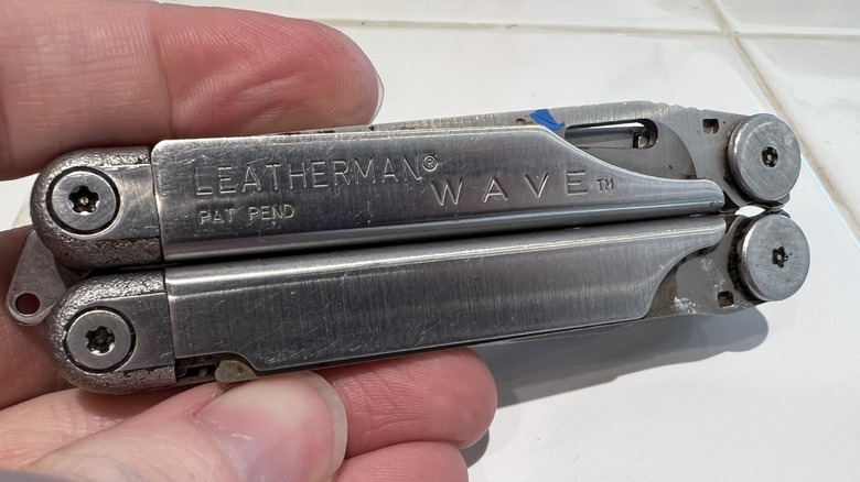 A hand holding a multitool