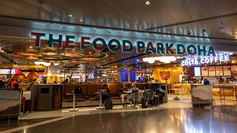 Entrance and sign for The Food Park Doha in the Doha Airport