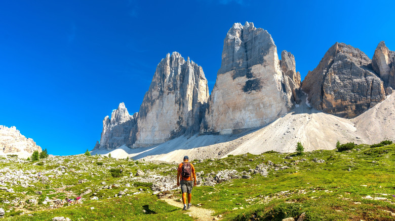 a hiker walking in the dolomites during the summer