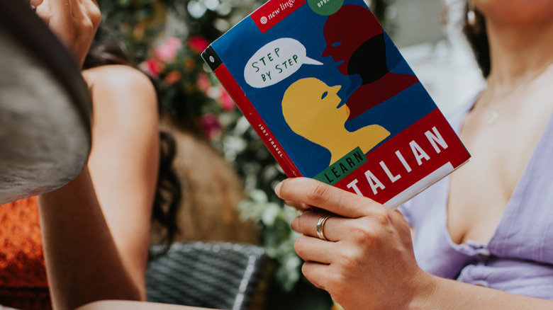 Woman reading Italian learning book