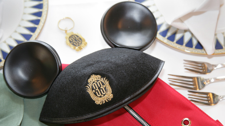 Club 33 merchandise, including Mickey ears hat and keychain on table at Club 33 inside Disneyland
