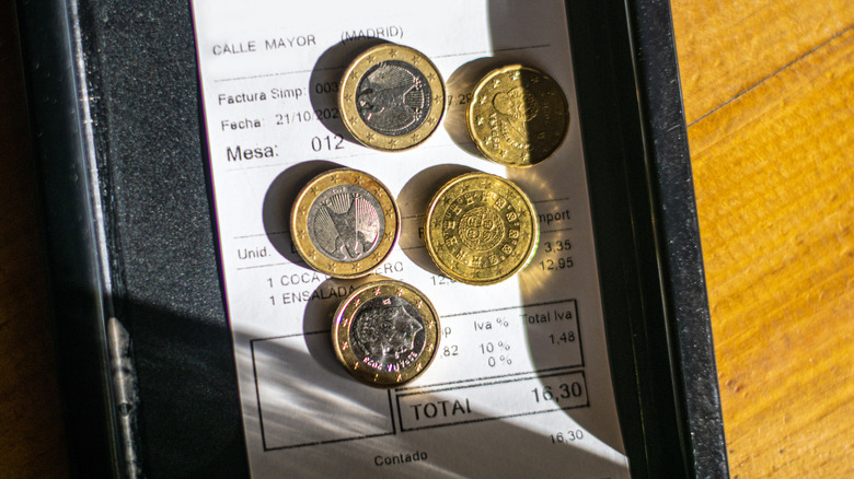 coins on a bill in restaurant
