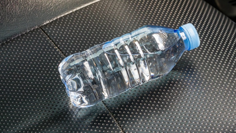 A water bottle on a car seat