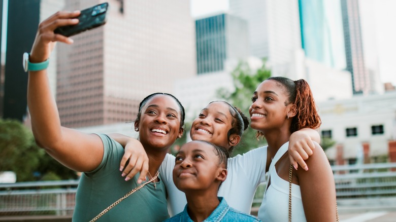 A happy family takes a group selfie in downtown Houston, Texas
