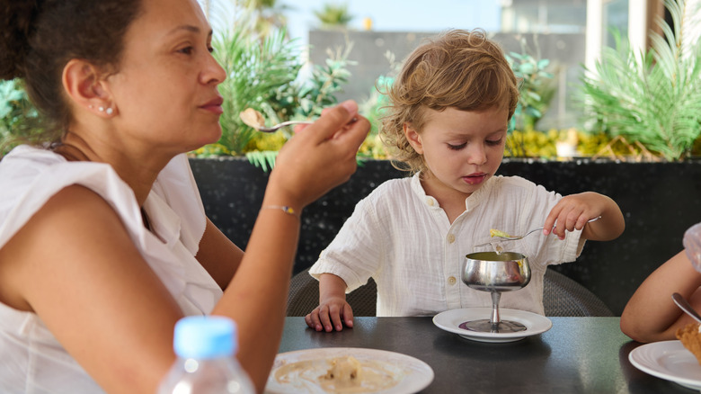 Woman and a child eating a meal