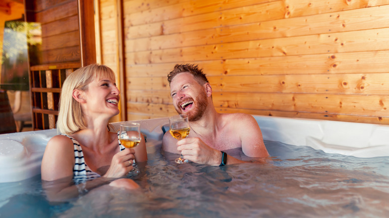 Couple having drinks in a hot tub