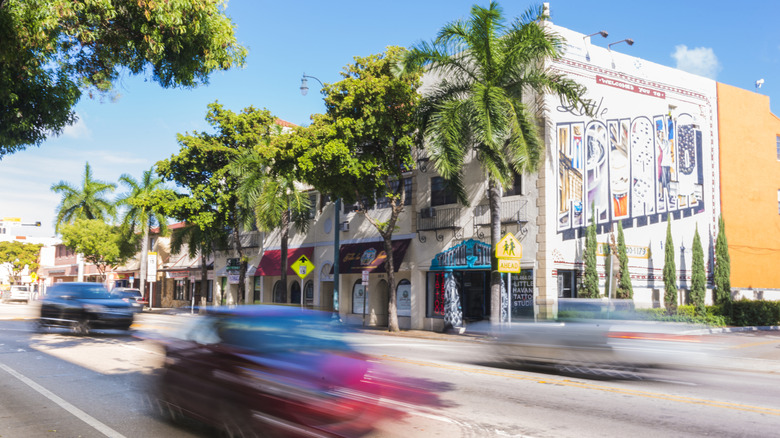 Cars driving on Calle Ocho pass the famous street in a motion blur from a long exposure
