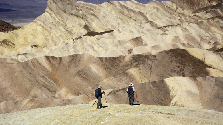 Two hikers at Zabriskie Point in Death Valley National Park