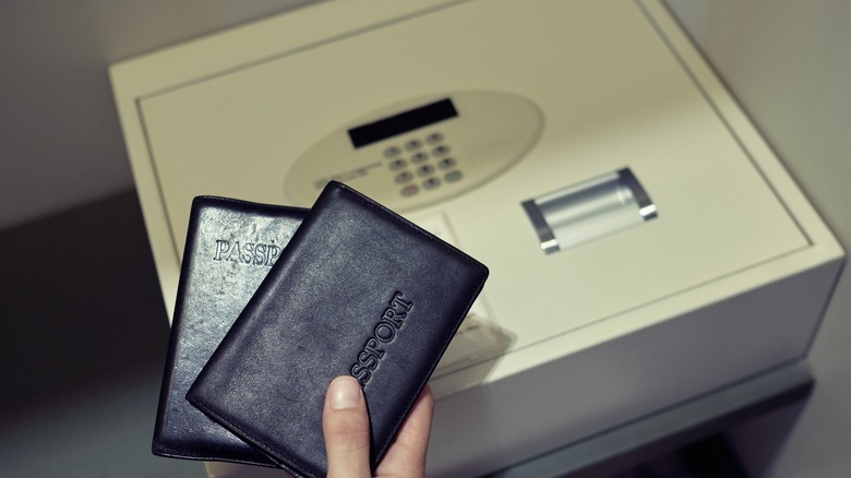 Someone putting passports in a hotel safe