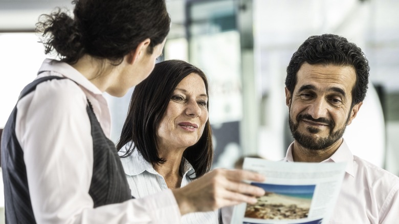 A couple speaking with a travel agent