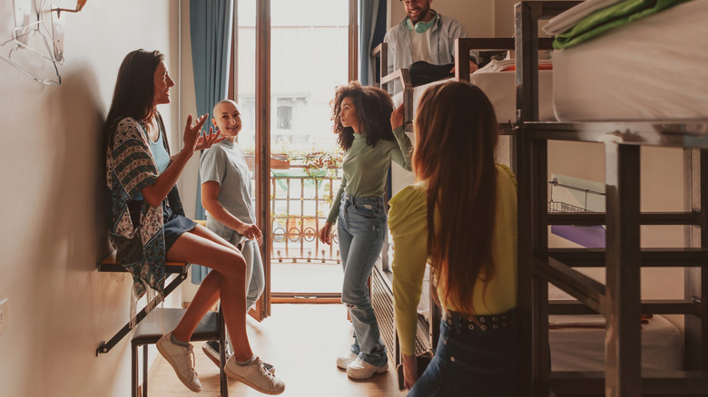Backpackers sharing experiences in a hostel.