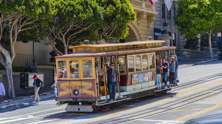 People riding one of the famous cable cars of San Francisco