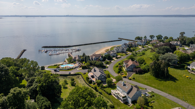 Aerial view of waterfront residences in Glen Cove, New York on a sunny summer day