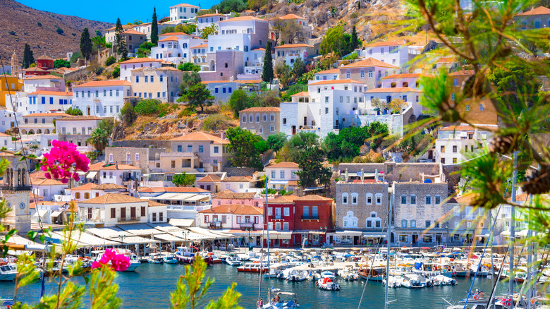 Panoramic view of Hydra coastline with colorful stone mansions along hillside