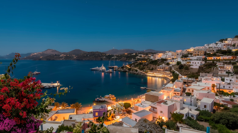 nighttime view of the whitewashed port town by the sea in Leros
