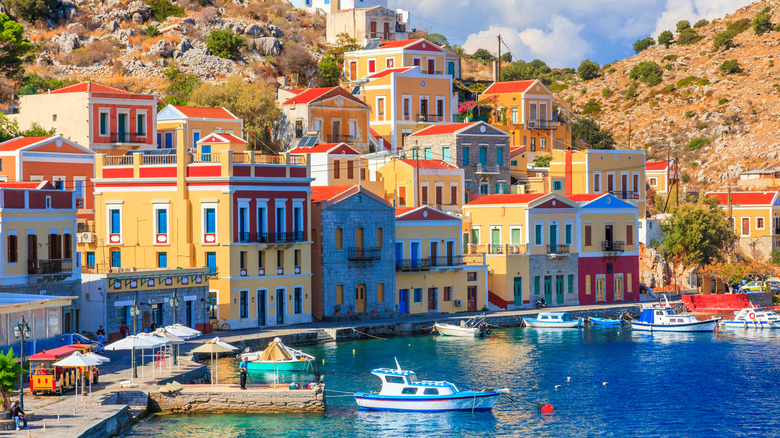 pastel colored neo classical houses along the harbor coastline