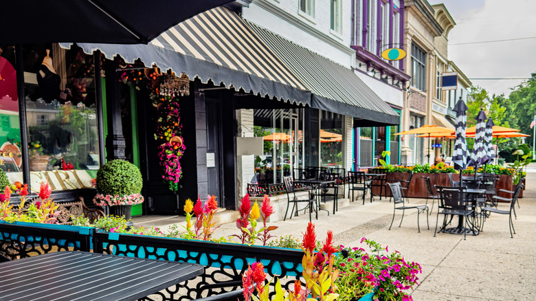 Colorful flowers line the outdoor seating of a restaurant on Broadway Street in Granville Ohio.
