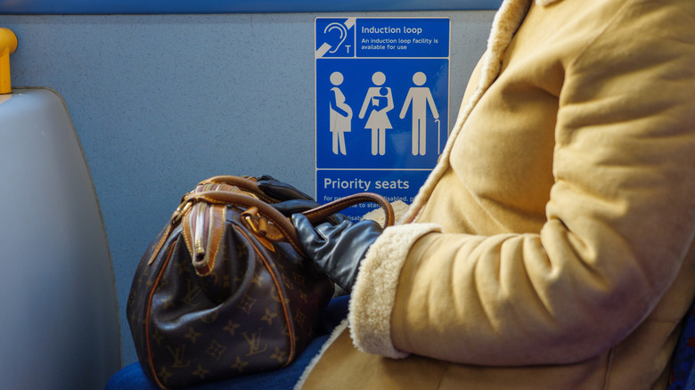 Person sitting in priority seat