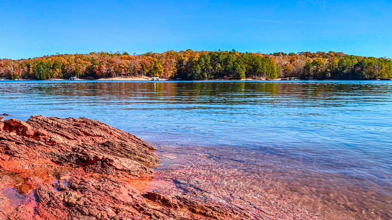 Colorful distant shoreline of Lanier Lake in Georgia lined with fall foliage