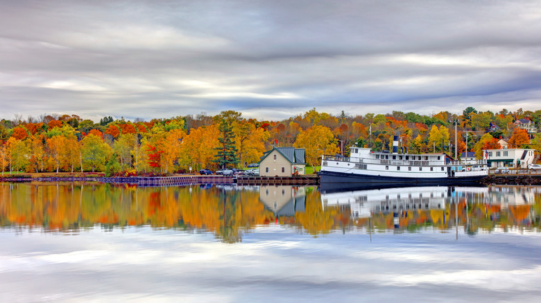 A picturesque harbor town located along the shores of Moosehead Lake, Maine, with colorful fall foliage.