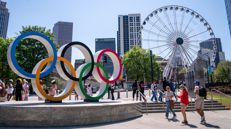 People walking near the Olympic Statue at Centennial Olympic Park in Atlanta, Georgia
