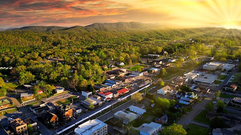 An aerial view of Blue Ridge, Georgia, at sunset with trees and mountains in the background