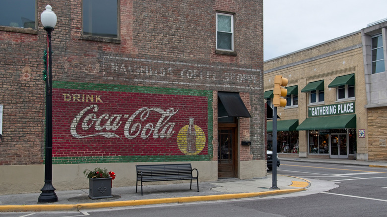 A street corner in Dayton, Tennessee, with brick buildings and an old advertisement painted on the side