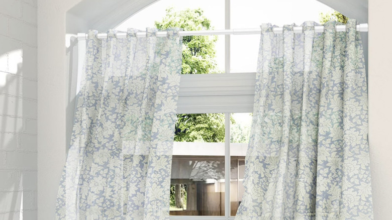 View of Genreen white tension rod being used as a curtain rod in a residential home