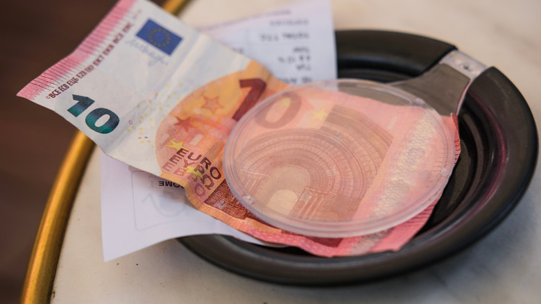 Restaurant bill tray with 10 euro tip