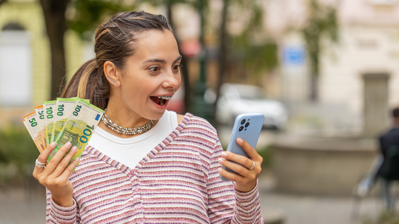 A woman delighted with her savings in Europe.