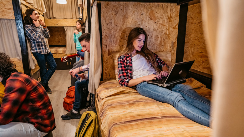 A group of travelers spending time in a hostel