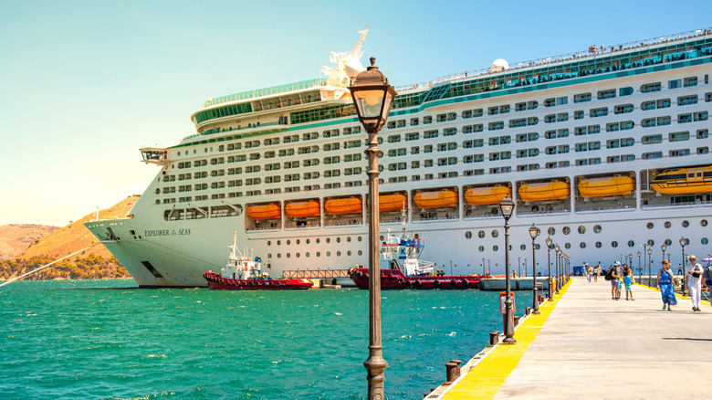 Royal Caribbean Explorer of the Seas docked in European Port with guests walking into the port city
