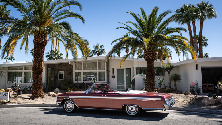 Red convertible car in front of mid-century modern house in Palm Springs, California