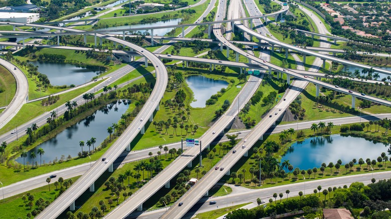 Aerial view of freeway interchanges in Miami, Florida, surrounded by swampland