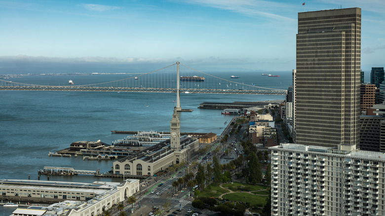 Aerial view of boulevard near San Francisco's Ferry Building with bridge and bay in background