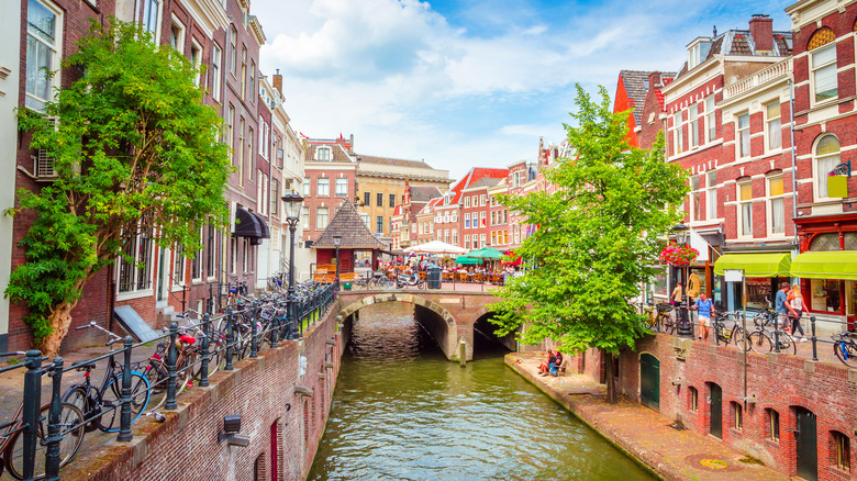 Canal lined with bikes and historic buildings in Utrecht, Netherlands