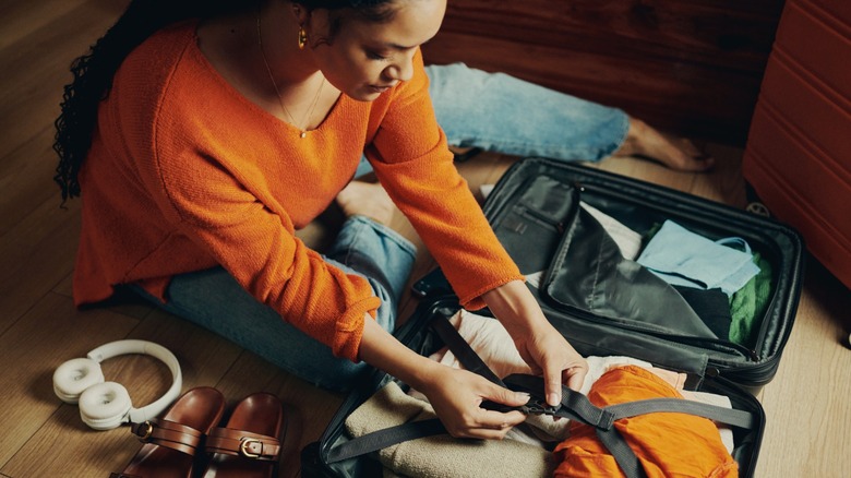 A woman packing her suitcase