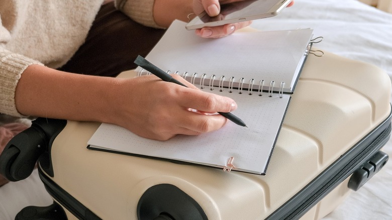 A traveler packing their bag