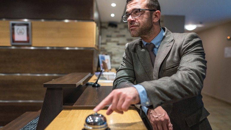 A man checking into a hotel