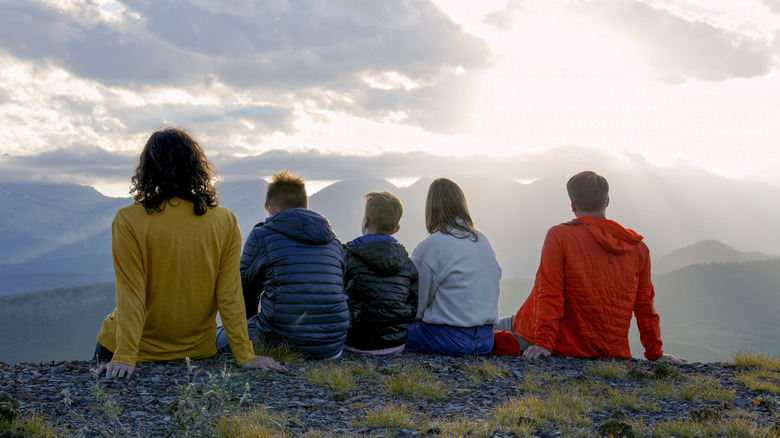 A group of friends watching a peak in the Canadian rockies