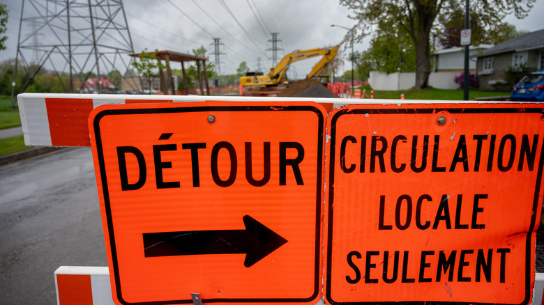 Road repair site with French road sign in foreground