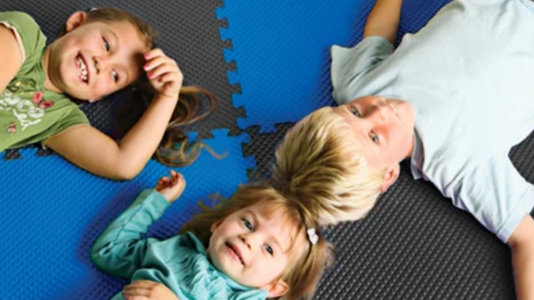 Children lying on foam mats