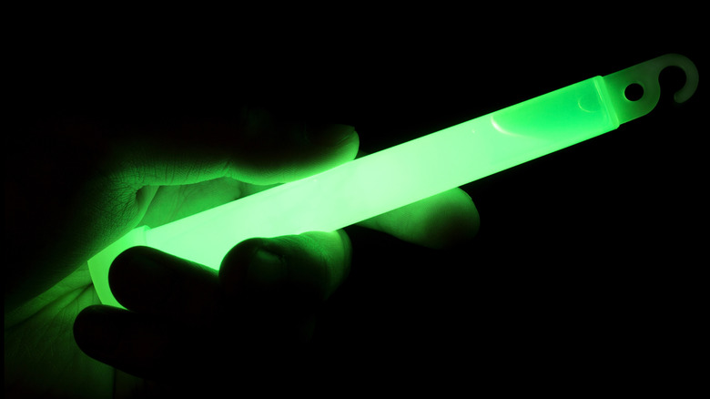 A hand holding a glow stick