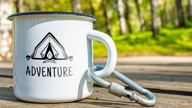 A carabiner attached to a mug at a campsite
