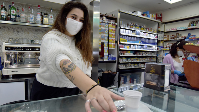 Barista prepares coffee for customer in Rome