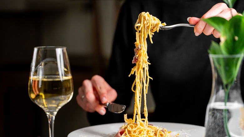 Woman twirling spaghetti on fork