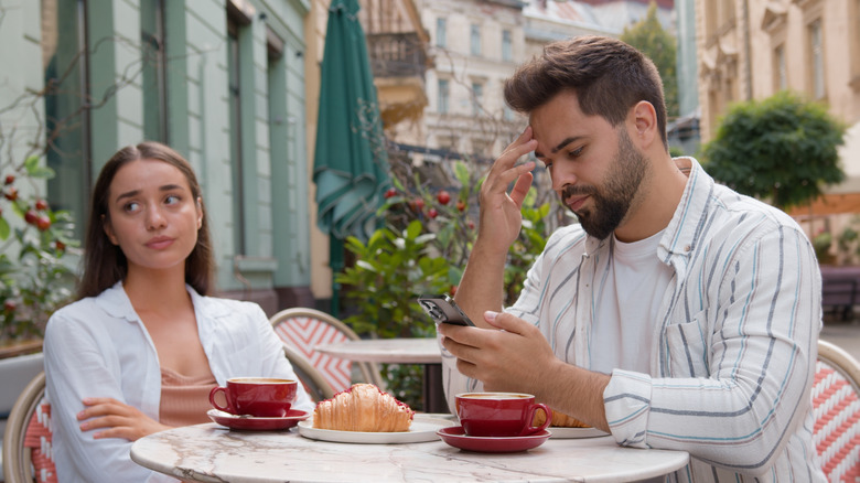 Man at Italian cafe on smartphone