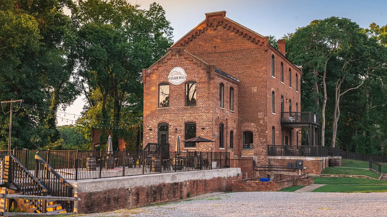 A side view of the historic brick Weldon Mills Distillery building in Weldon, North Carolina