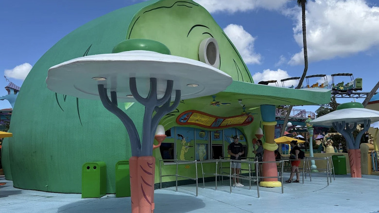 Exterior of colorful Green Eggs and Ham Cafe shaped like a ham at Universal Islands of Adventure theme park.